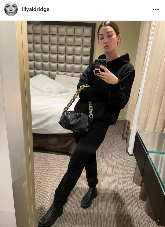 Lily Aldridge wearing jet black core Les Tien Hoodie and Sweats and holding a thick link gold chain handbag in an IG selfie