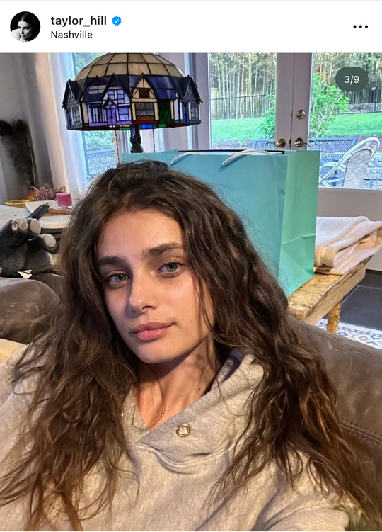 Taylor Hill instagram post in grey Les Tien hoodie with gold eyelets