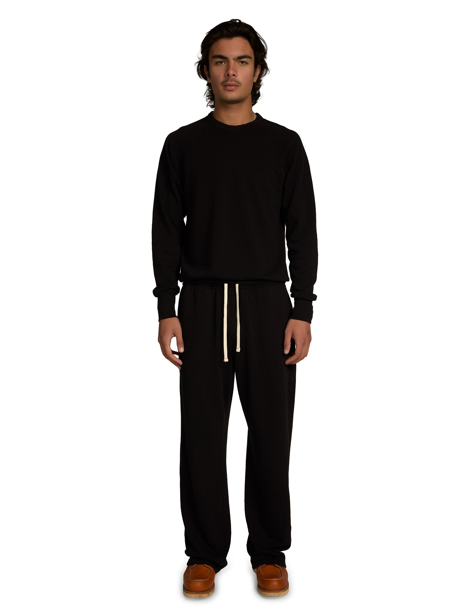 Person wearing a black outfit with a white background