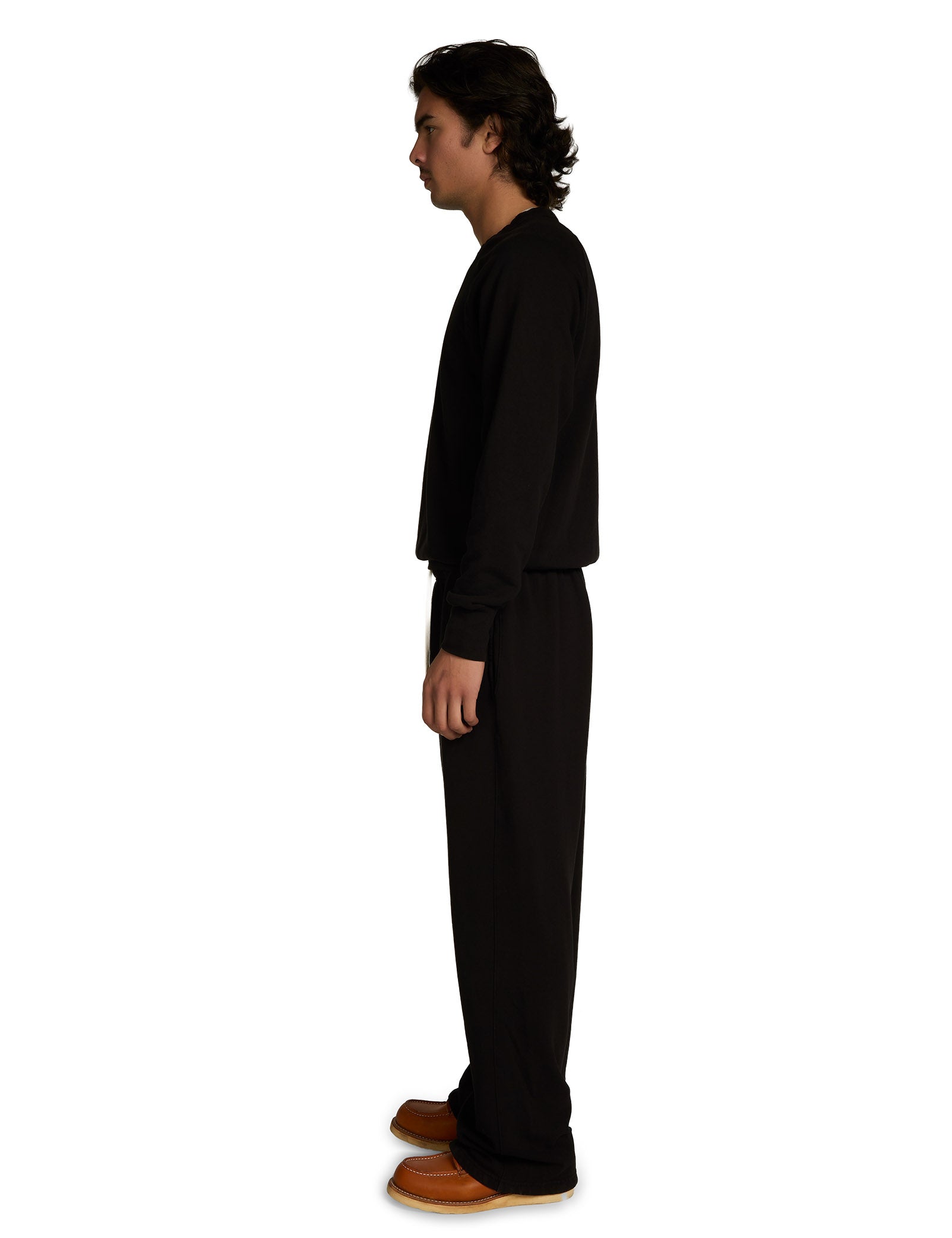 Person wearing a black outfit on a white background