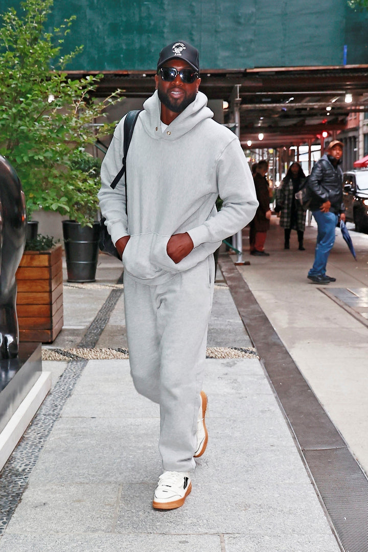 Dwayne Wade wearing grey sweatsuit by Les tien - hoodie with gold eyelets