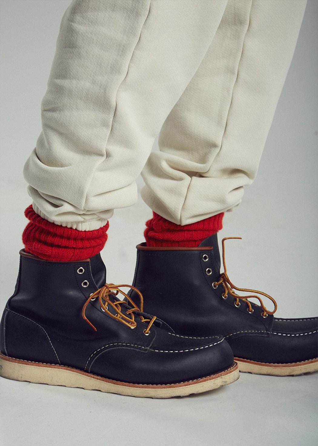 Red Cashmere Socks from Les Tien being worn with boots and sweats. Unisex sizing.